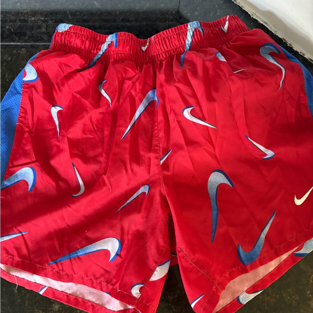 Nike Red Athletic Shorts with Blue & White Swoosh Print